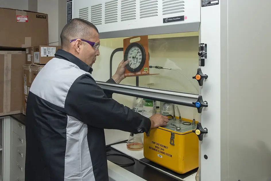 Pressure gauge being calibrated in a NASA aircraft-support calibration laboratory